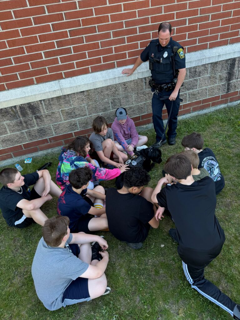 Officer Ireland and Sasha greet the students